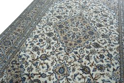 Backside of handmade 2000s Kashan rug showing knot structure and weave density