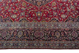 Corner detail of 2000s Kashan rug showing border pattern and Wool pile