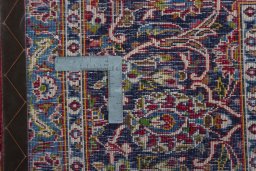 Backside of handmade 2000s Kashan rug showing knot structure and weave density
