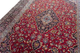 Backside of handmade 2000s Kashan rug showing knot structure and weave density