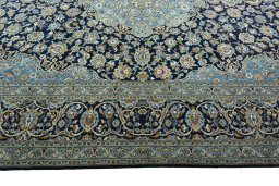 Corner detail of 2000s Kashan rug showing border pattern and Wool pile