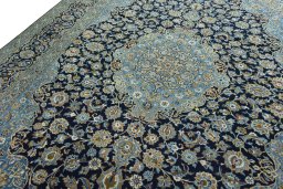 Backside of handmade 2000s Kashan rug showing knot structure and weave density