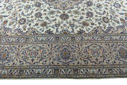 Corner detail of 2000s Kashan rug showing border pattern and Wool pile