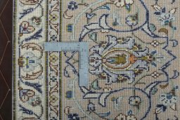 Backside of handmade 2000s Kashan rug showing knot structure and weave density