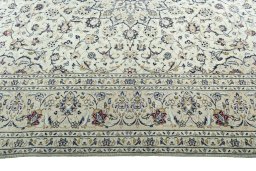 Corner detail of 2000s Kashan rug showing border pattern and Wool pile