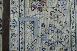 Backside of handmade 2000s Kashan rug showing knot structure and weave density
