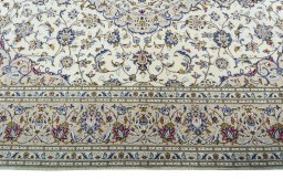 Corner detail of 2000s Kashan rug showing border pattern and Wool pile