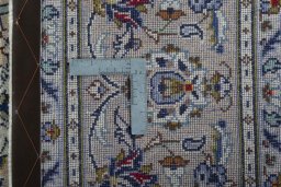 Backside of handmade 2000s Kashan rug showing knot structure and weave density