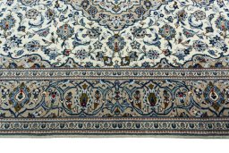 Corner detail of 2000s Kashan rug showing border pattern and Wool pile