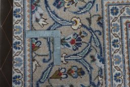Backside of handmade 2000s Kashan rug showing knot structure and weave density