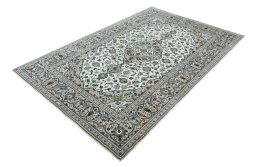 Corner detail of 2000s Kashan rug showing border pattern and Wool pile