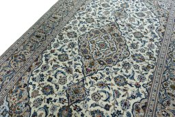 Backside of handmade 2000s Kashan rug showing knot structure and weave density