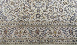 Corner detail of 2000s Kashan rug showing border pattern and Cork pile