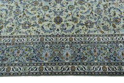 Corner detail of 2000s Kashan rug showing border pattern and Wool pile