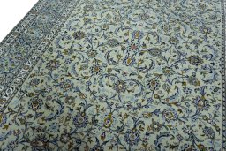 Backside of handmade 2000s Kashan rug showing knot structure and weave density