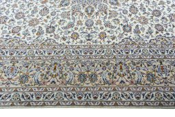 Corner detail of 2000s Kashan rug showing border pattern and Wool pile