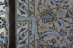Backside of handmade 2000s Kashan rug showing knot structure and weave density