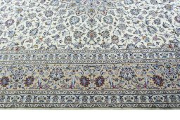 Corner detail of 2000s Kashan rug showing border pattern and Wool pile