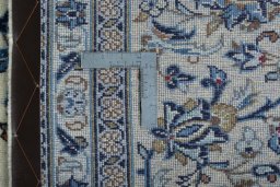Backside of handmade 2000s Kashan rug showing knot structure and weave density