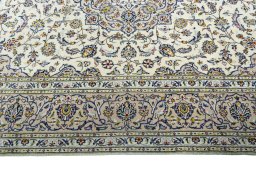 Corner detail of 2000s Kashan rug showing border pattern and Wool pile