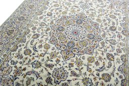 Backside of handmade 2000s Kashan rug showing knot structure and weave density