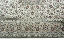 Corner detail of 2000s Kashan rug showing border pattern and Wool pile