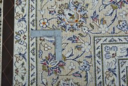 Backside of handmade 2000s Kashan rug showing knot structure and weave density