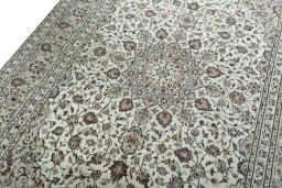 Backside of handmade 2000s Kashan rug showing knot structure and weave density