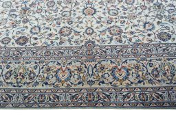 Corner detail of 2000s Kashan rug showing border pattern and Wool pile