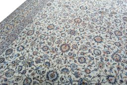 Backside of handmade 2000s Kashan rug showing knot structure and weave density
