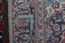 Backside of handmade 2000s Kashan rug showing knot structure and weave density
