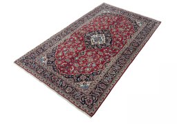 Corner detail of 2000s Kashan rug showing border pattern and Wool pile