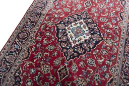 Backside of handmade 2000s Kashan rug showing knot structure and weave density