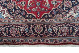 Full view of 2000s Kashan rug from Iran / Persia, 254 × 152 cm in Red tones
