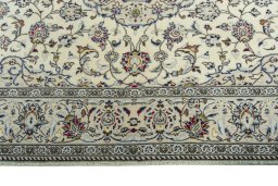 Corner detail of 2000s Kashan rug showing border pattern and Wool pile