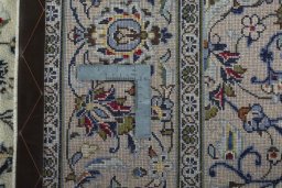Backside of handmade 2000s Kashan rug showing knot structure and weave density