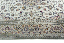 Corner detail of 2000s Kashan rug showing border pattern and Wool pile