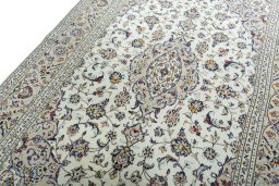 Backside of handmade 2000s Kashan rug showing knot structure and weave density