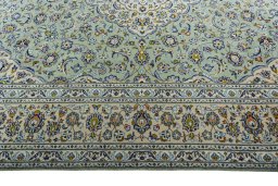 Corner detail of 2000s Kashan rug showing border pattern and Wool pile
