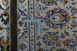 Backside of handmade 2000s Kashan rug showing knot structure and weave density