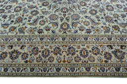 Corner detail of 2000s Kashan rug showing border pattern and Wool pile