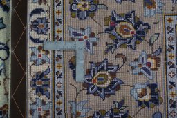 Backside of handmade 2000s Kashan rug showing knot structure and weave density
