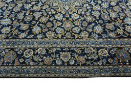 Corner detail of 2000s Kashan rug showing border pattern and Wool pile