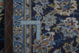 Backside of handmade 2000s Kashan rug showing knot structure and weave density