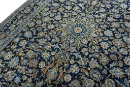 Backside of handmade 2000s Kashan rug showing knot structure and weave density