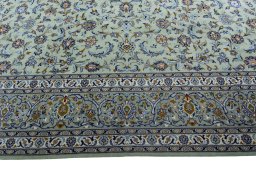 Corner detail of 2000s Kashan rug showing border pattern and Wool pile