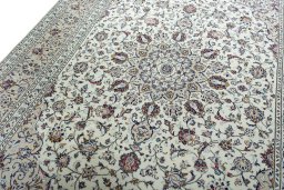 Backside of handmade 2000s Kashan rug showing knot structure and weave density