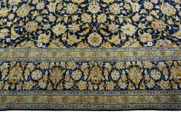 Corner detail of 2000s Kashan rug showing border pattern and Wool pile