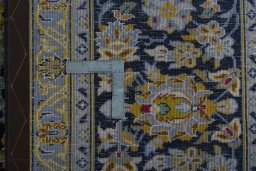 Backside of handmade 2000s Kashan rug showing knot structure and weave density