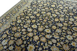 Backside of handmade 2000s Kashan rug showing knot structure and weave density